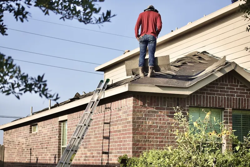 Professional roofer working on a residential roof in Three Tuns